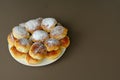 Homemade old fashioned apple dumplings or pies on a white plate and brown background. Baked according to Ukraine recipe. Royalty Free Stock Photo