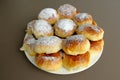 Homemade old fashioned apple dumplings or pies on a white plate and brown background. Baked according to Ukraine recipe. Royalty Free Stock Photo