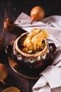 Homemade onion soup with cheese croutons in a pot on the table vertical view Royalty Free Stock Photo