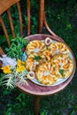 Homemade open apricot pie shortcrust pastry with apricot filling, peonies in the background