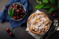 Homemade open cherry pie with lattice on a dark concrete background. Selective focus. Top view