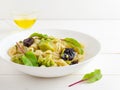 Homemade orecchiette pasta with broccoli, sun-dried tomatoes and herbs on a white wooden table. Italian dish, vegan, vegetarian Royalty Free Stock Photo