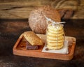 Coconut cookies, diet candy bars and whole coconut on a wooden background.