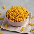 Homemade Organic Dried Riccioli Pasta in a Pink Bowl, low angle view