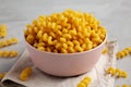 Homemade Organic Dried Riccioli Pasta in a Pink Bowl, side view