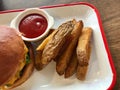 Homemade Organic Potato Wedges with Ketchup served Hamburger Plate Tray at Fast Food Restaurant Royalty Free Stock Photo