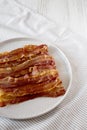 Homemade Oven Baked Bacon on a Gray Plate, side view. Copy space Royalty Free Stock Photo