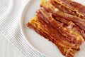 Homemade Oven Baked Bacon on a Gray Plate, side view. Copy space Royalty Free Stock Photo