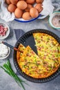 Homemade oven baked frittata with curd cheese, bacon, onion and chives Royalty Free Stock Photo