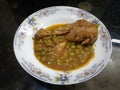 homemade Pakistani chicken curry with pea in traditional plate