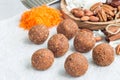 Homemade paleo energy balls with carrot, nuts, dates and coconut flakes, on parchment, horizontal, copy space Royalty Free Stock Photo