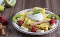 Homemade pancake with vanilla curd, raspberries, kiwi and banana pieces sprinkled with cocoa Royalty Free Stock Photo