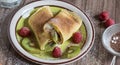 Homemade pancake with vanilla curd, raspberries, kiwi and banana pieces sprinkled with cocoa Royalty Free Stock Photo