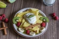 Homemade pancake with vanilla curd, raspberries, kiwi and banana pieces sprinkled with cocoa Royalty Free Stock Photo