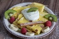 Homemade pancake with vanilla curd, raspberries, kiwi and banana pieces sprinkled with cocoa Royalty Free Stock Photo