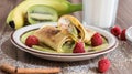 Homemade pancake with vanilla curd, raspberries, kiwi and banana pieces sprinkled with cocoa Royalty Free Stock Photo