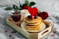 Homemade pancakes with berries, cup of tea and flowers and gift box. Breakfast or brunch for Valentine`s Day Royalty Free Stock Photo