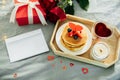 Homemade pancakes with berries, flowers and gift box. Breakfast or brunch for Valentine`s Day. Mockup. Blank for greeting card fo Royalty Free Stock Photo