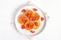 Homemade pancakes with cottage cheese and strawberry slices, syrniki