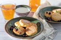 Homemade pancakes with cottage cheese on a white lantern with black currants and cranberries. Breakfast for the whole family. Royalty Free Stock Photo