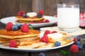 Homemade pancakes with fresh berries, honey and glass of milk Royalty Free Stock Photo