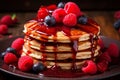 Homemade pancakes with fresh raspberries, blueberries, and maple syrup for breakfast Royalty Free Stock Photo