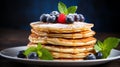 Homemade pancakes with fresh strawberries, blueberries, and maple syrup for breakfast, copy space Royalty Free Stock Photo