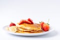 Homemade Pancakes with fresh strawberries and slice banana and honey on white plate,Healthy breakfast Royalty Free Stock Photo