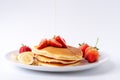 Homemade Pancakes with fresh strawberries and slice banana and honey on white plate,Healthy breakfast Royalty Free Stock Photo