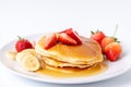 Homemade Pancakes with fresh strawberries and slice banana and honey on white plate,Healthy breakfast Royalty Free Stock Photo