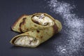 Homemade pancakes with green spirulina stuffed white cottage cheese with raisins on a black slate background, close up Royalty Free Stock Photo