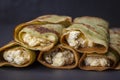 Homemade pancakes with green spirulina stuffed white cottage cheese with raisins on a black slate background Royalty Free Stock Photo