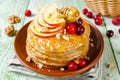 Homemade pancakes with honey, apple, cranberries and nuts Royalty Free Stock Photo