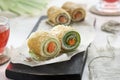 Homemade pancakes rolls with red fish, soft cheese and cucumber