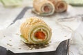 Homemade pancakes rolls with soft cheese and salmon