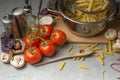 Homemade pasta cooking in a pot of water and cooking ingredients with a cutting board, top view. The concept of Italian cuisine an Royalty Free Stock Photo