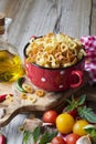 Homemade pasta. Traditional Italian in the form of hearts in a red ceramic pot before cooking Royalty Free Stock Photo