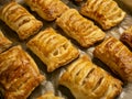 Homemade pastries freshly baked puff pastry puffs with apples on baking paper close-up. Bakery products Royalty Free Stock Photo