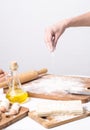 Homemade pastries: a woman sprinkles flour on the dough.