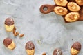 Almond cookies and raw almonds on wooden cutting board over white background, close-up, selective focus. Royalty Free Stock Photo