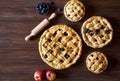 Homemade pastry apple pie bakery products on dark wooden kitchen table with raisins and apples. Traditional dessert on Royalty Free Stock Photo