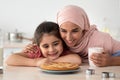 Homemade Pastry. Happy Islamic Mom And Daughter Looking At Freshly Baked Pie Royalty Free Stock Photo