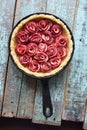 Homemade pastry. Open pie with apple roses in cast iron pan on s Royalty Free Stock Photo