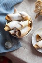 Homemade pastry. The rugelach with jam in a white bowl on a table.