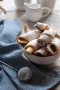 Homemade pastry. The rugelach with jam in a white bowl on a table.