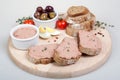 Homemade pate, olives, tomatoes, eggs and slices of bread on wooden board Royalty Free Stock Photo