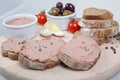 Homemade pate, olives, tomatoes and slices of bread on wooden board Royalty Free Stock Photo