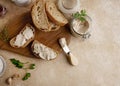 Homemade pate, spread or mousse in glass jar with sliced bread and herbs with pine nuts, light concrete background. Royalty Free Stock Photo