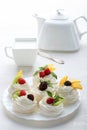 Homemade mini pavlova cakes with whipped cream and fresh berries