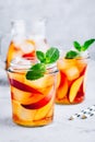 Homemade peach iced tea or lemonade with fresh mint and ice cubes in glass jar Royalty Free Stock Photo